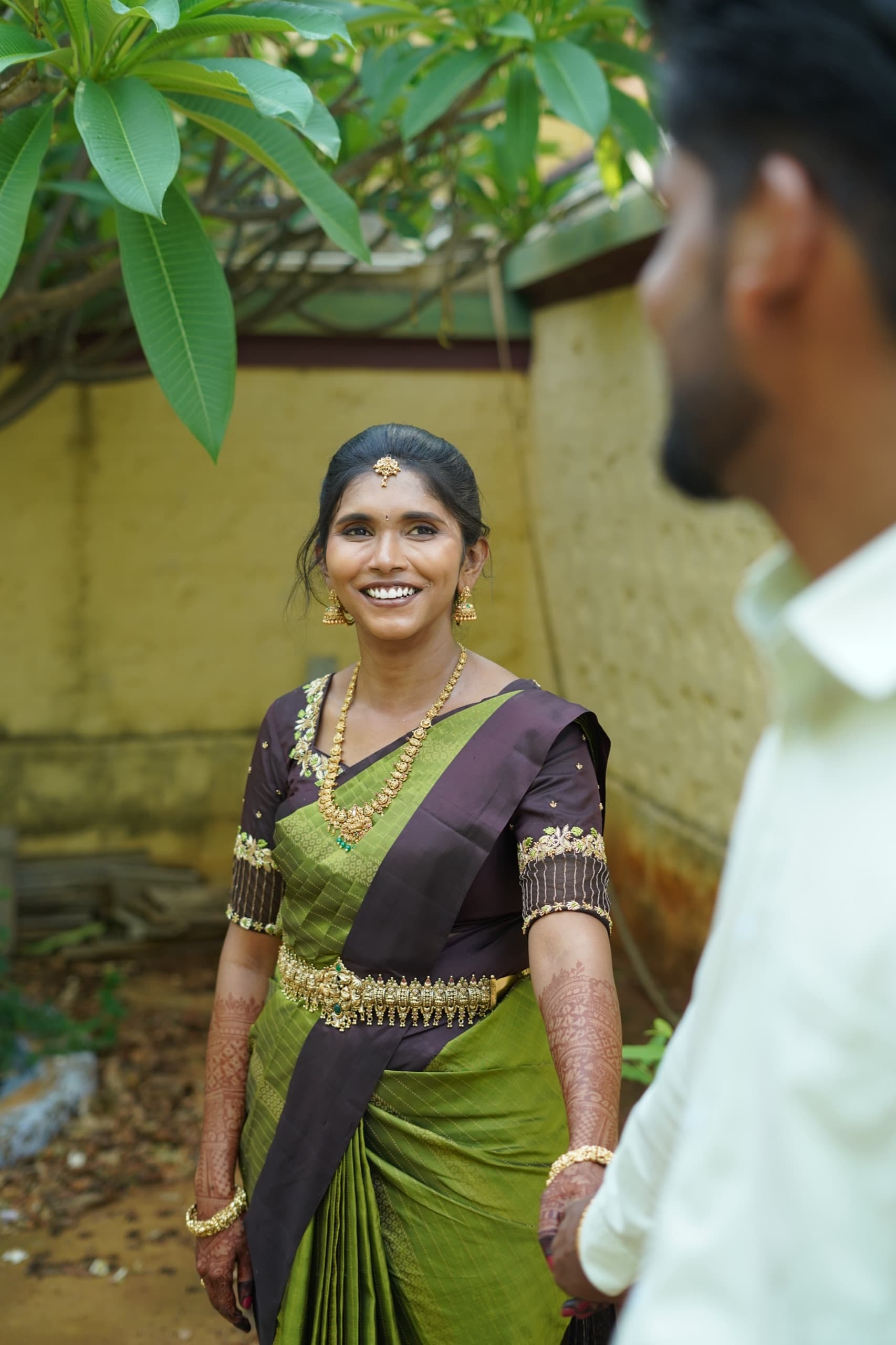Bride smiling in green saree