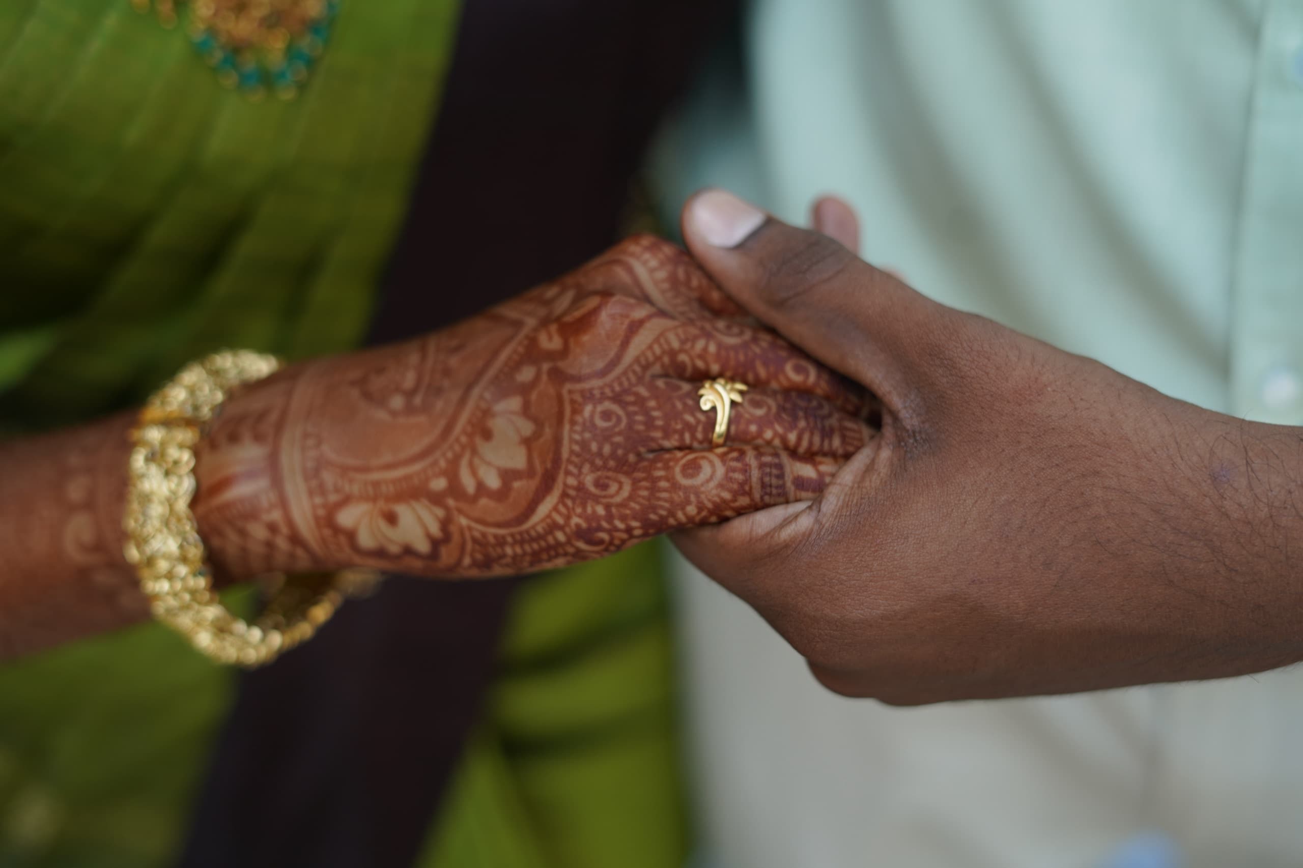 Henna-adorned hands held together
